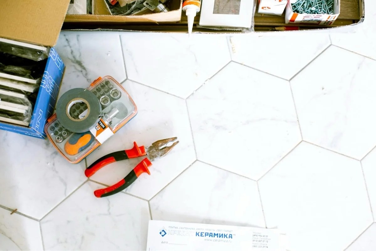 floor tile with tools lying on top