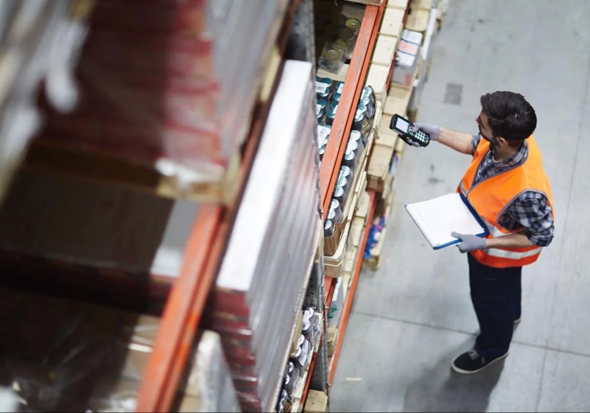 man scanning inventory in a warehouse