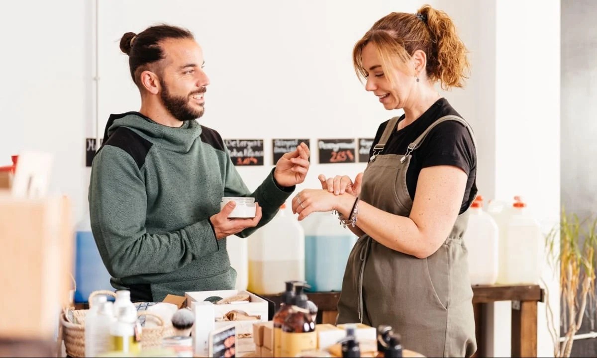 store employee showing a product to a customer