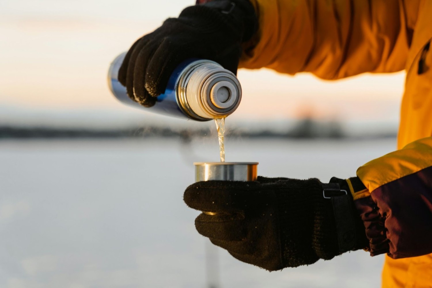 pouring hot water from a thermos