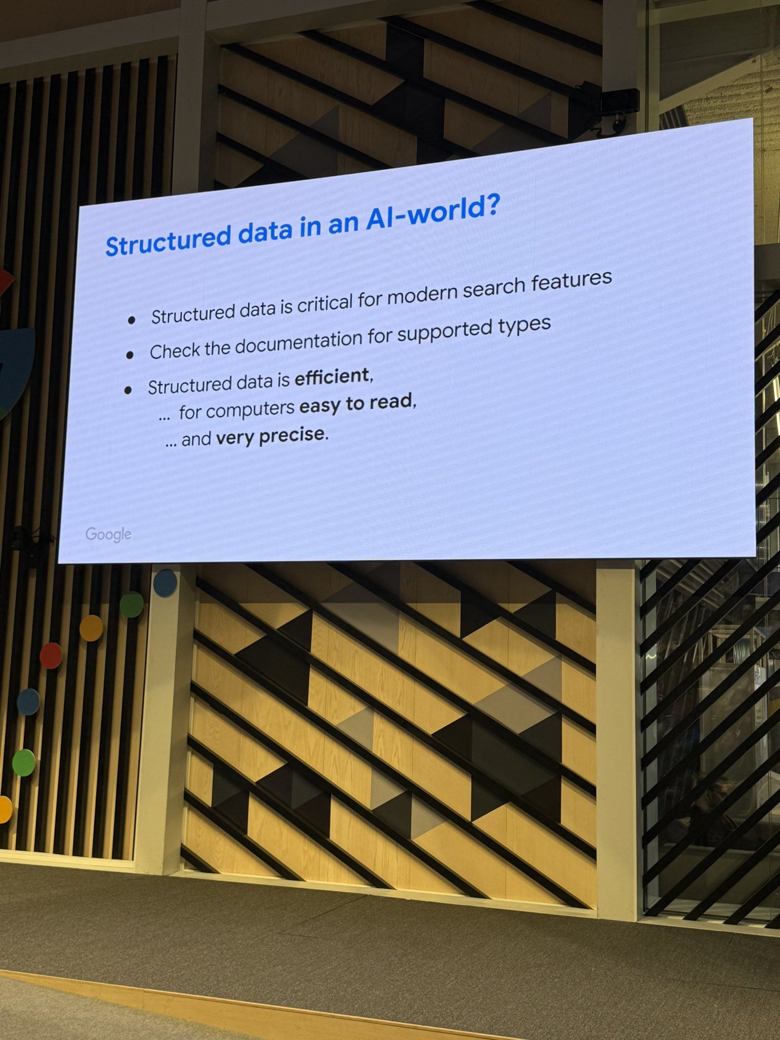Google presentation slide titled "Structured data in an AI-world?" with three bullet points about structured data's importance for search features and efficiency.